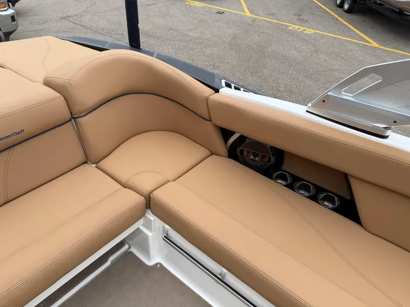 Slide: The Image of 2018 MasterCraft XT23 boat interior with tan leather seating and speaker system. - 14