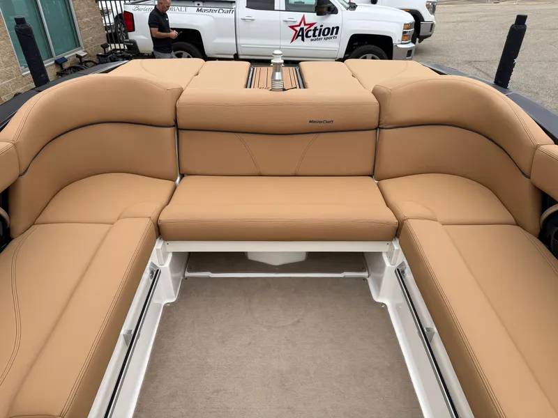 Slide: The Image of 2018 MasterCraft XT23 boat interior with tan leather seating and spacious layout. - 15