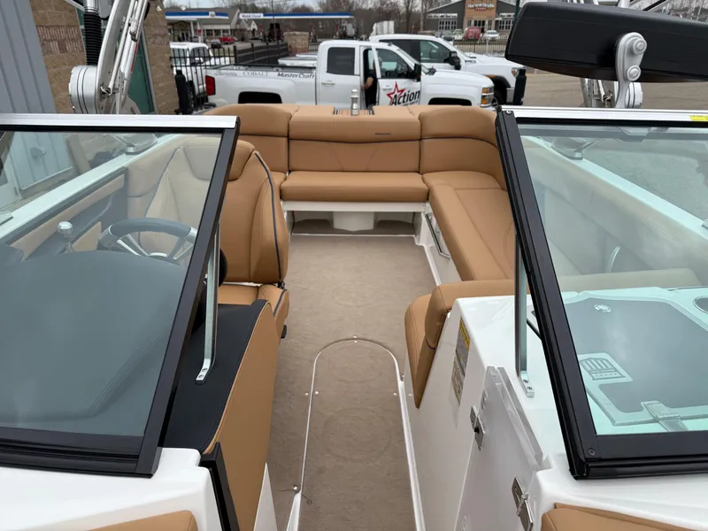 Slide: The Image of 2018 MasterCraft XT23 boat interior with tan seating and modern design. - 16