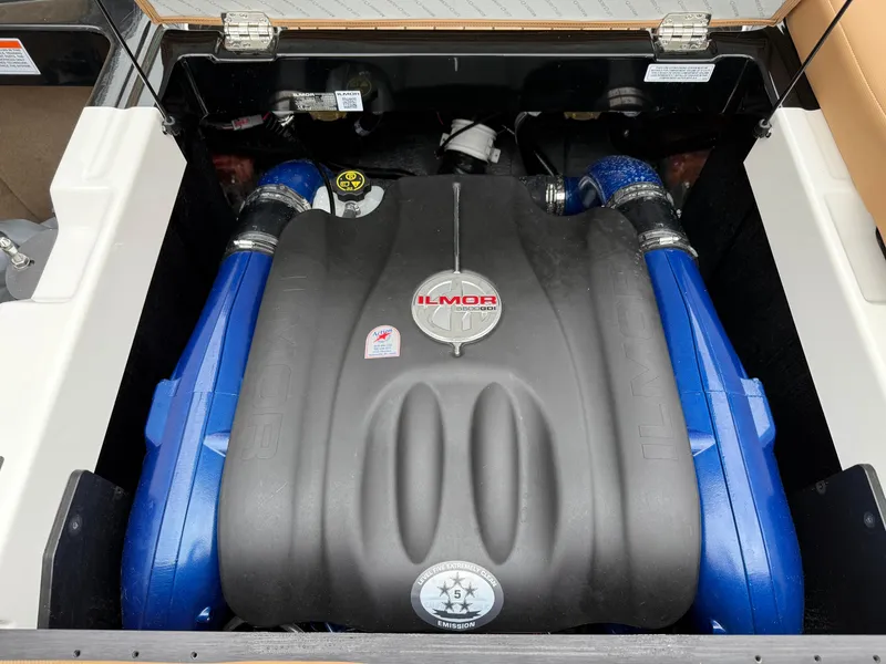 Slide: The Image of 2018 MasterCraft XT23 Ilmor engine with blue accents, open engine compartment. - 18