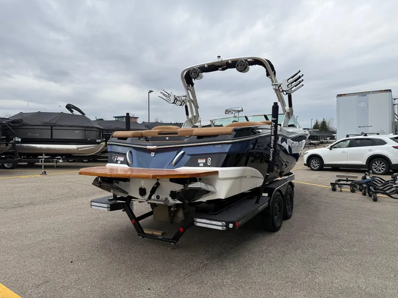 Slide: The Image of 2018 MasterCraft XT23 boat on trailer in parking lot, overcast sky. - 5