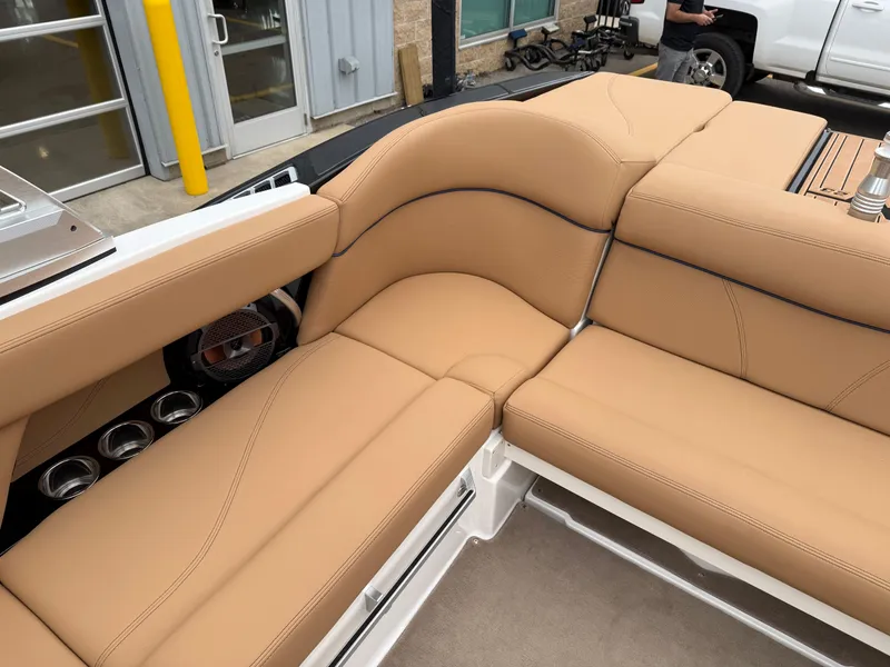 Slide: The Image of 2018 MasterCraft XT23 boat interior with tan leather seating and cup holders. - 9