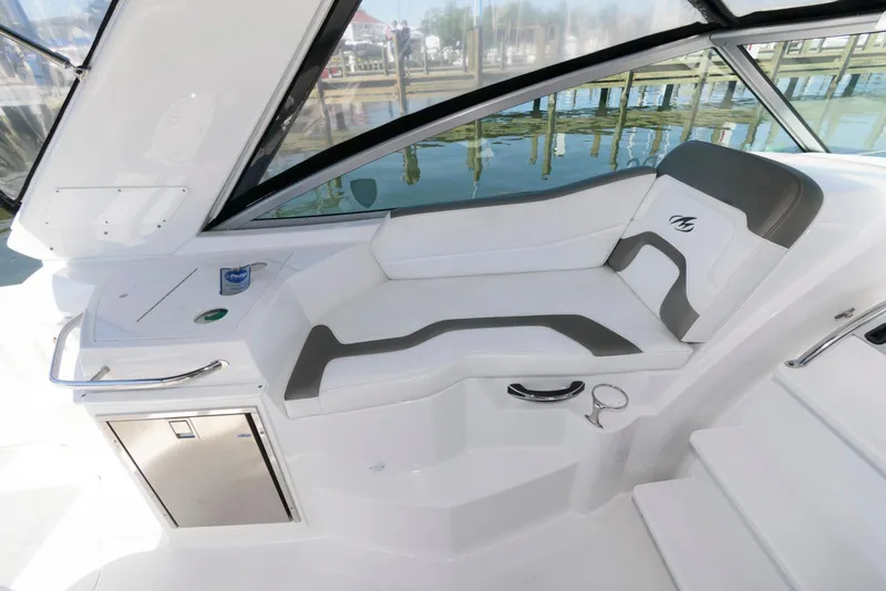 Slide: The Image of 2019 Monterey 295 Sport Yacht interior with sleek white seating and modern design. - 10