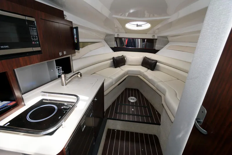 Slide: The Image of Interior of 2019 Monterey 295 Sport Yacht with kitchenette and seating area. - 11