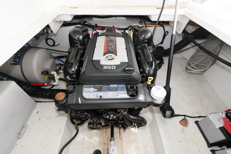 Slide: The Image of Engine compartment of a 2019 Monterey 295 Sport Yacht, featuring a 350 horsepower engine. - 16
