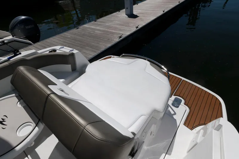 Slide: The Image of 2019 Monterey 295 Sport Yacht, rear seating and deck, docked by the water. - 4