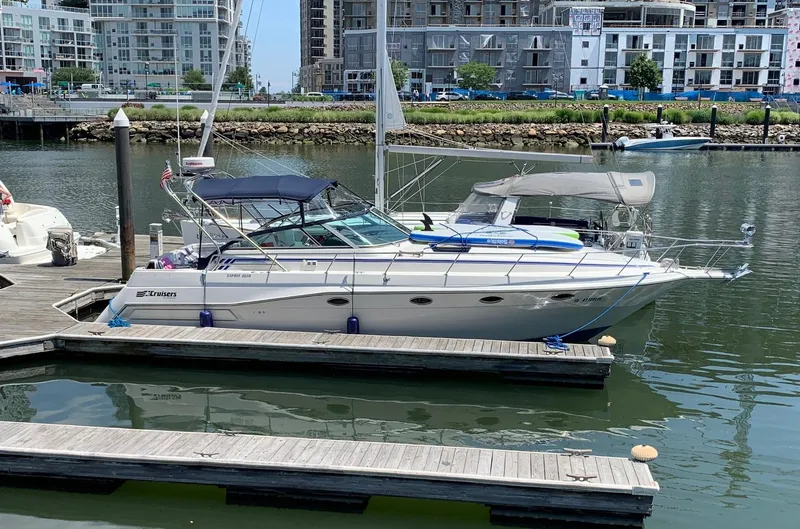 The Image of 1989 Cruisers Yachts 3670 Esprit docked in a marina with urban backdrop. - 0
