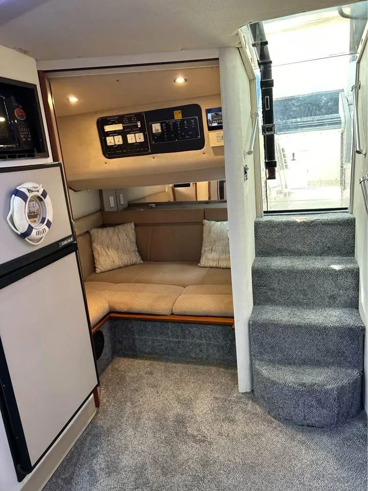 Slide: The Image of 1989 Cruisers Yachts 3670 Esprit interior with cozy seating and carpeted stairs. - 10