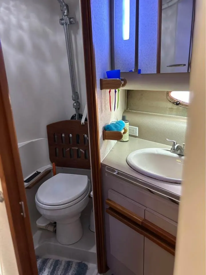 Slide: The Image of 1989 Cruisers Yachts 3670 Esprit bathroom with shower, sink, and toilet. - 11