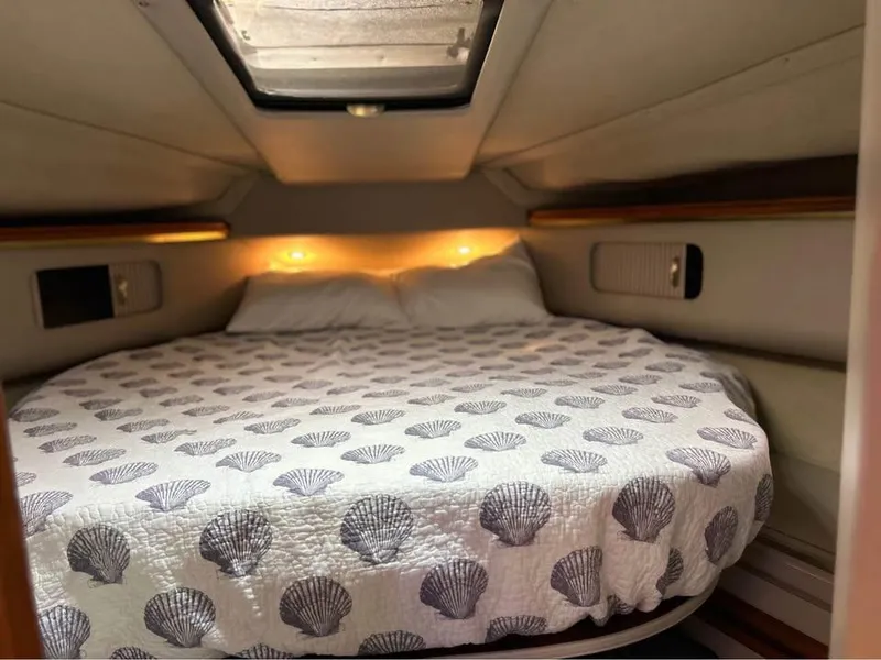 Slide: The Image of Cozy cabin interior of 1989 Cruisers Yachts 3670 Esprit with shell-patterned bedding. - 9