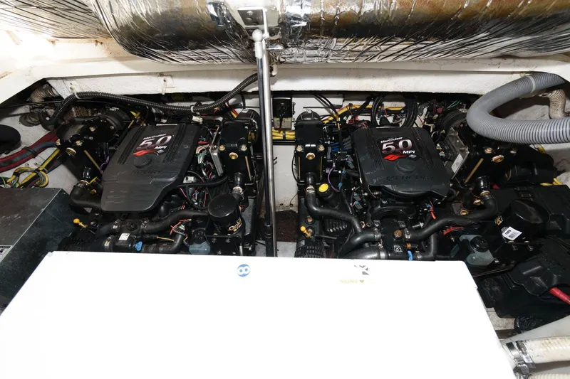 Slide: The Image of Engine compartment of a 2008 Maxum 2900 SE boat, featuring dual 5.0 MPI engines. - 16