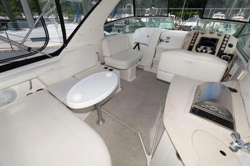 Slide: The Image of 2008 Maxum 2900 SE boat interior with seating, table, and helm. - 4