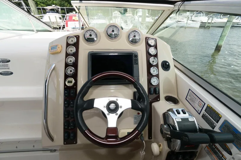 Slide: The Image of 2008 Maxum 2900 SE boat dashboard with steering wheel and control panel. - 7