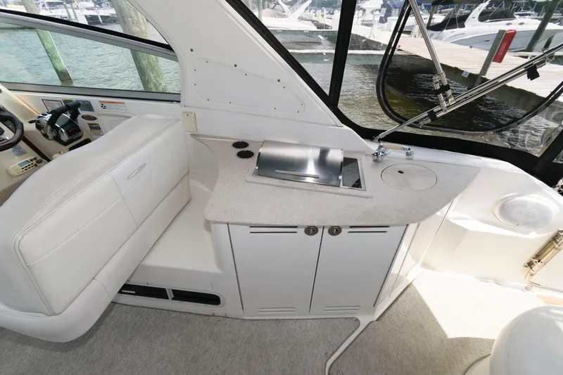 Slide: The Image of 2008 Maxum 2900 SE boat interior with kitchenette and seating area. - 8