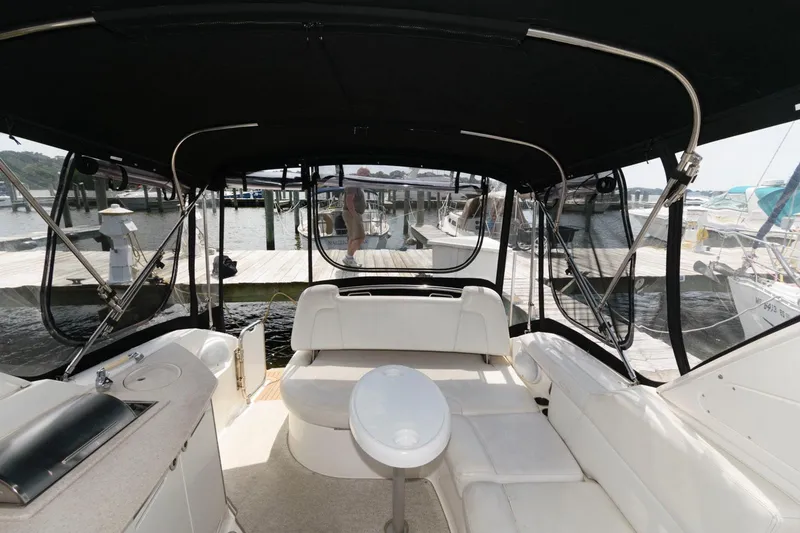 Slide: The Image of 2008 Maxum 2900 SE boat interior with seating and canopy at a marina. - 9