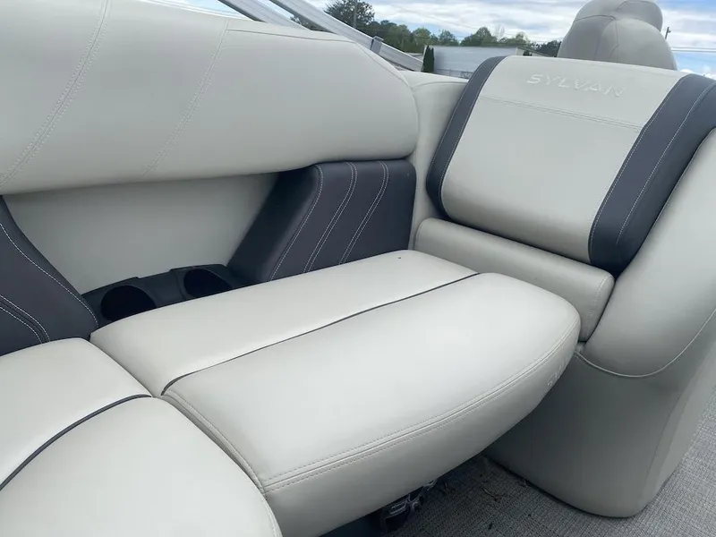Slide: The Image of 2023 Sylvan 822 LZ Mirage boat interior with plush seating and cup holders. - 10