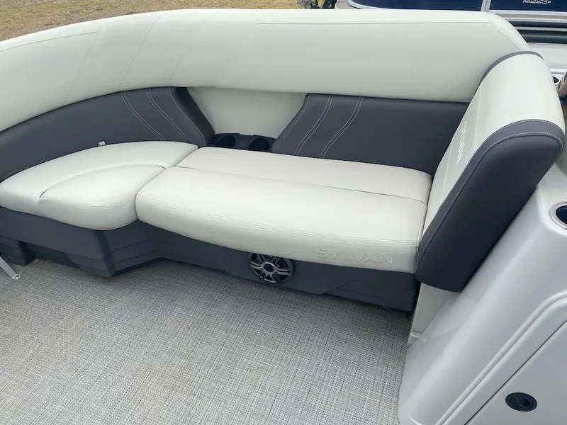 Slide: The Image of 2023 Sylvan 822 LZ Mirage boat interior with white and gray seating. - 11
