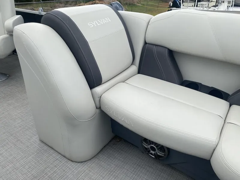 Slide: The Image of 2023 Sylvan 822 LZ Mirage boat seating with gray upholstery and integrated speaker. - 13