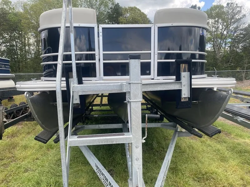 Slide: The Image of 2023 Sylvan 822 LZ Mirage pontoon boat on trailer, parked on grass. - 14