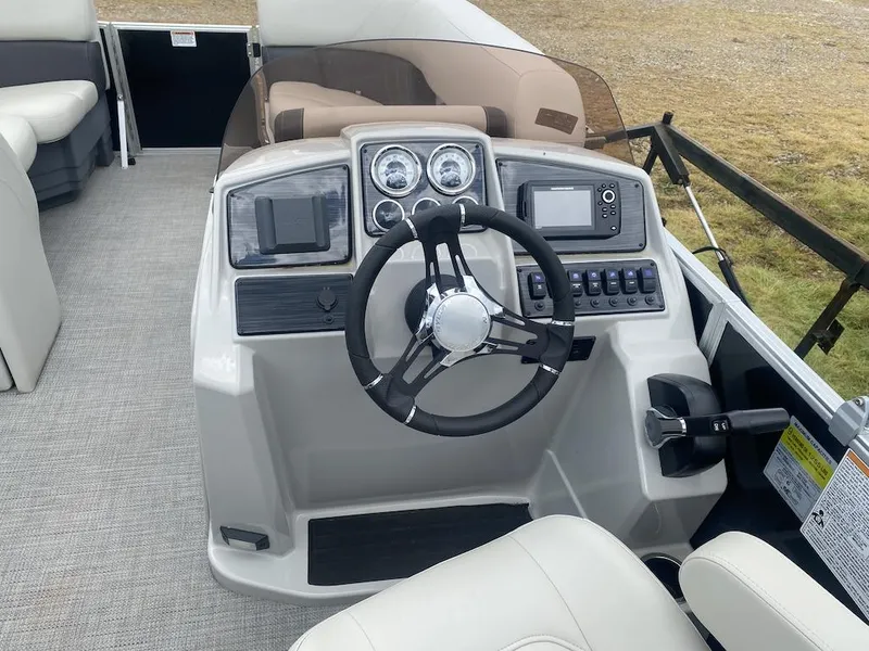 Slide: The Image of 2023 Sylvan 822 LZ Mirage boat dashboard with steering wheel and control panel. - 4