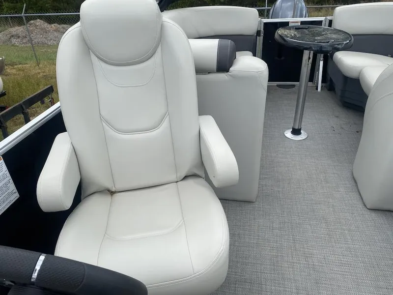 Slide: The Image of 2023 Sylvan 822 LZ Mirage boat interior with white seating and a small table. - 6