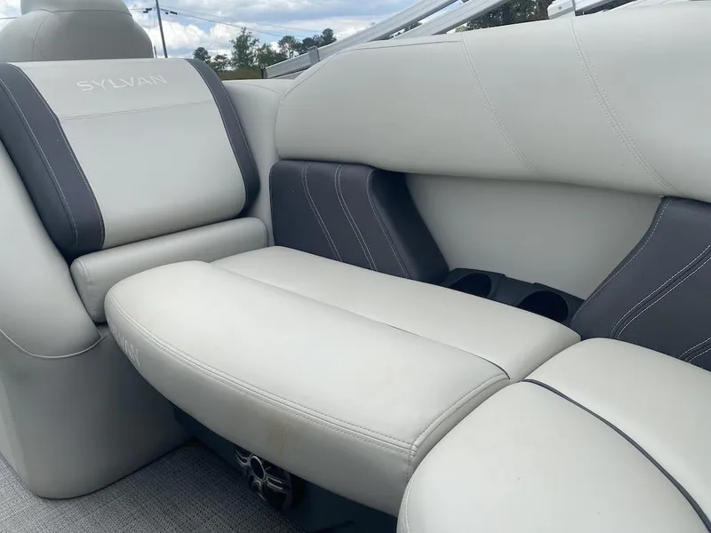 Slide: The Image of 2023 Sylvan 822 LZ Mirage boat interior with plush seating and cup holders. - 9