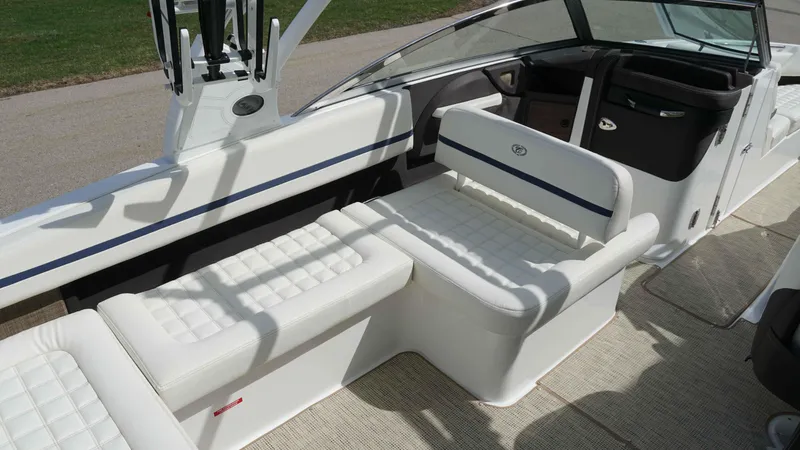Slide: The Image of 2019 Cobalt R7 boat interior with white cushioned seating and sleek design. - 10