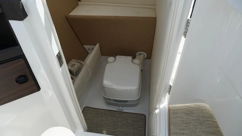 Slide: The Image of Compact bathroom in 2019 Cobalt R7 boat with portable toilet and storage. - 14