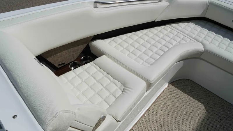 Slide: The Image of Luxurious white seating on a 2019 Cobalt R7 boat, featuring quilted upholstery and cup holders. - 16