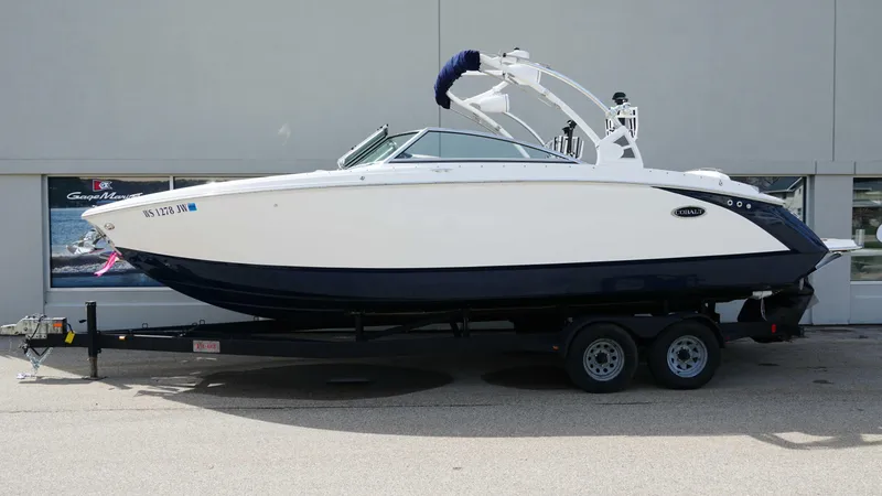Slide: The Image of 2019 Cobalt R7 boat on trailer, white and navy design, parked outdoors. - 2