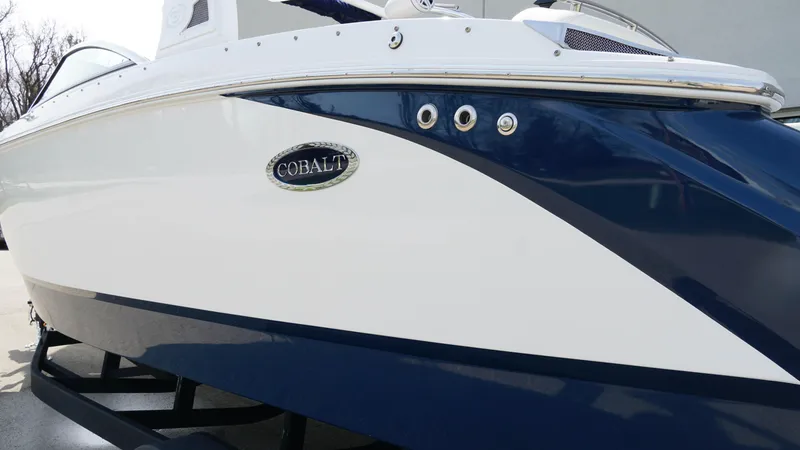 Slide: The Image of 2019 Cobalt R7 boat with sleek white and blue design on a trailer. - 4
