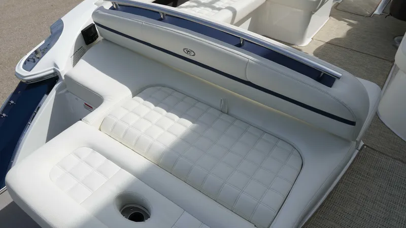 Slide: The Image of 2019 Cobalt R7 boat interior with white cushioned seating and cup holder. - 7