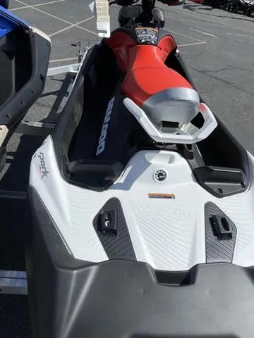 Slide: The Image of 2025 Sea-Doo Spark Trixx Waverunner, red and white, parked on trailer. - 15