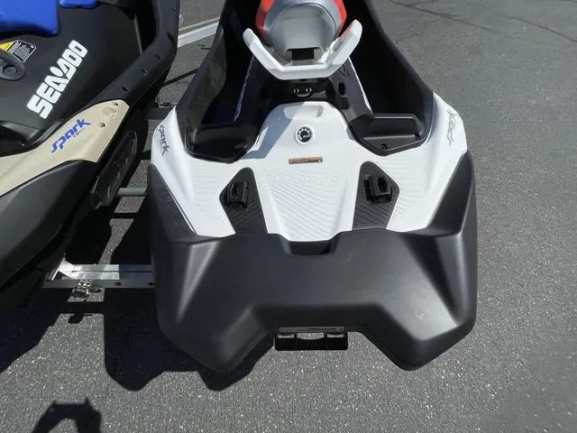 Slide: The Image of 2025 Sea-Doo Spark Trixx Waverunner, black and white design, parked on pavement. - 5