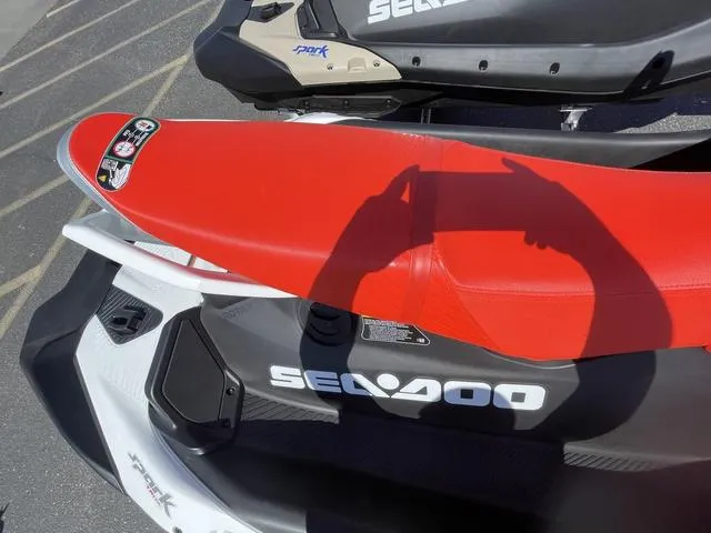 Slide: The Image of 2025 Sea-Doo Waverunner Spark Trixx with red seat and sleek design. - 7