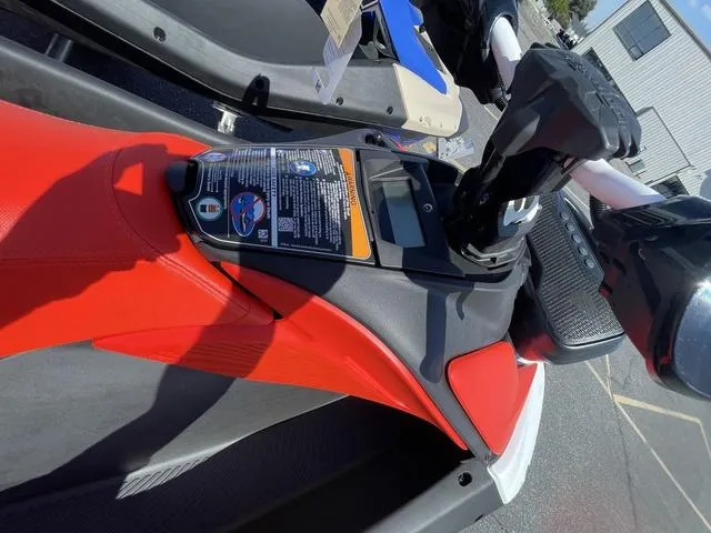 Slide: The Image of 2025 Sea-Doo Spark Trixx Waverunner, red seat, close-up view of controls and handlebars. - 8