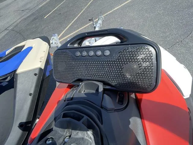 Slide: The Image of 2025 Sea-Doo Spark Trixx Waverunner with audio system, parked on asphalt. - 9