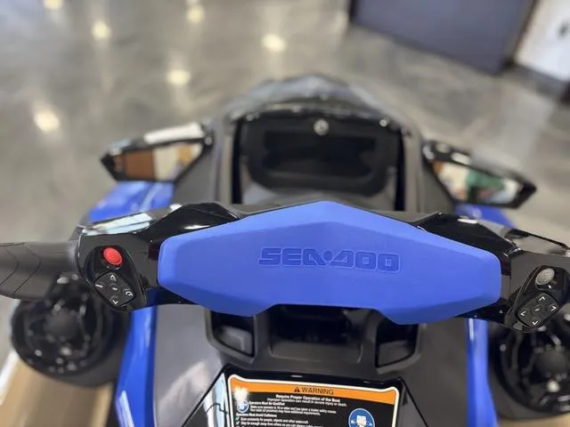 Slide: The Image of 2025 Sea-Doo Waverunner Wake handlebar with control buttons, featuring a sleek blue design. - 9