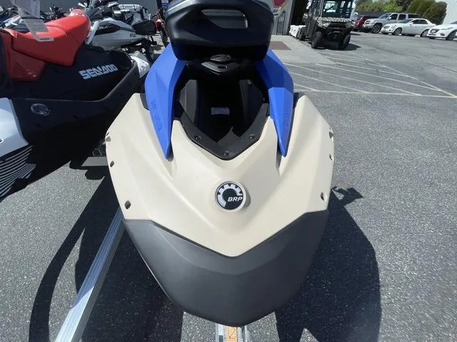 Slide: The Image of 2025 Sea-Doo Waverunner Spark Trixx, beige and blue, parked on pavement. - 10