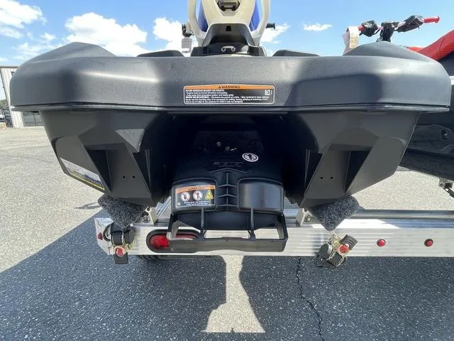 Slide: The Image of 2025 Sea-Doo Spark Trixx Waverunner on trailer, rear view, sunny day. - 5