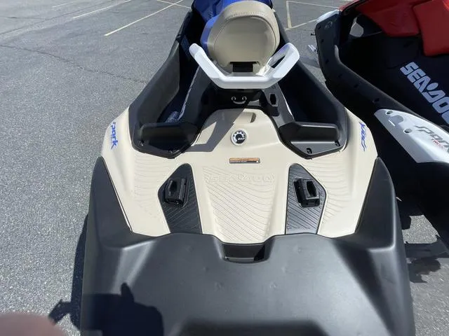 Slide: The Image of 2025 Sea-Doo Waverunner Spark Trixx, beige and black, parked on asphalt. - 6