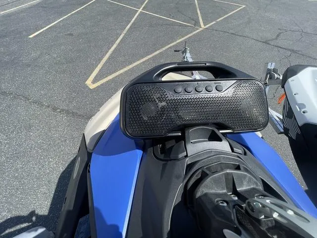 Slide: The Image of 2025 Sea-Doo Spark Trixx Waverunner with speaker system, parked on asphalt. - 8