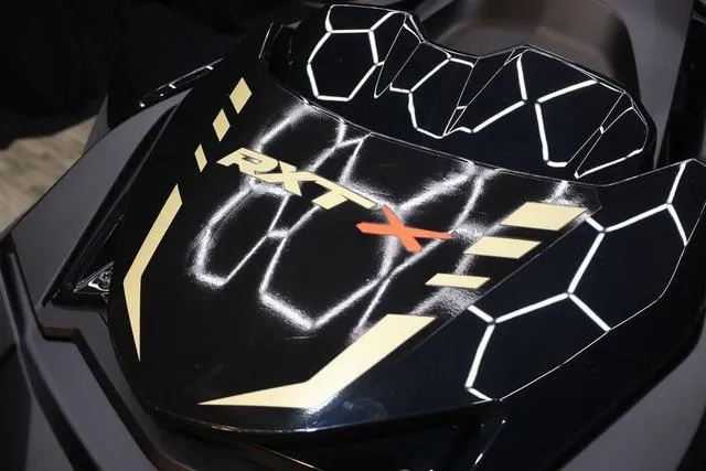 Slide: The Image of 2025 Sea-Doo Waverunner RXT-X in a garage, showcasing sleek design and vibrant colors. - 11