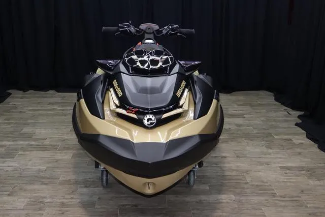 Slide: The Image of 2025 Sea-Doo Waverunner RXT-X dashboard with controls and display, on wooden floor. - 7