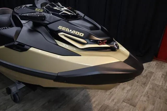 Slide: The Image of 2025 Sea-Doo Waverunner RXT-X in showroom, featuring sleek design and vibrant orange seat. - 9