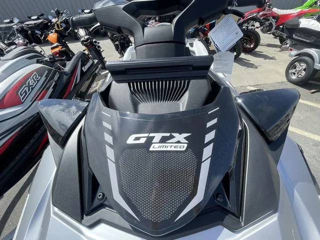 Slide: The Image of 2025 Sea-Doo Waverunner GTX Limited, sleek design, parked among other watercraft. - 12