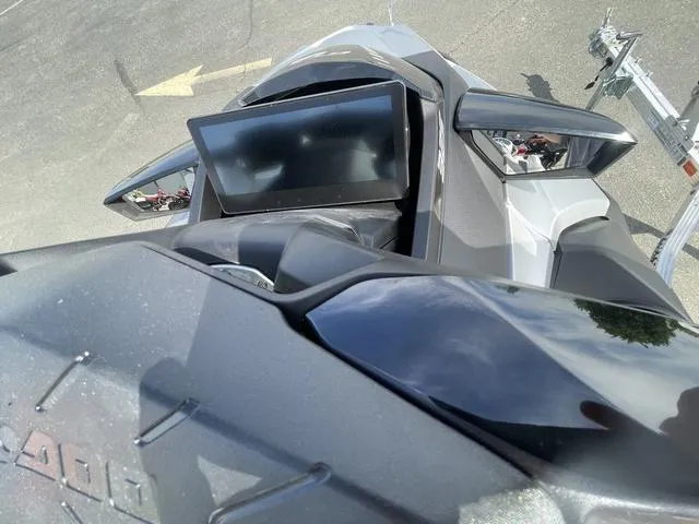 Slide: The Image of 2025 Sea-Doo Waverunner GTX dashboard and mirrors in a parking lot. - 14