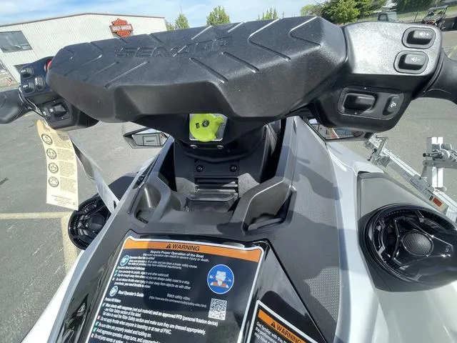 Slide: The Image of 2025 Sea-Doo Waverunner GTX dashboard with controls and warning labels in a parking lot. - 15
