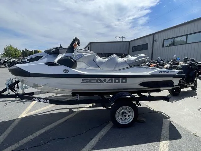 Slide: The Image of 2025 Sea-Doo Waverunner GTX on trailer, parked outdoors under a partly cloudy sky. - 5