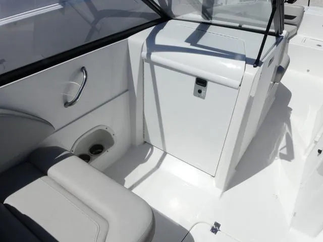 Slide: The Image of 2023 Hurricane SunDeck 235 OB interior with seating and storage compartment. - 14